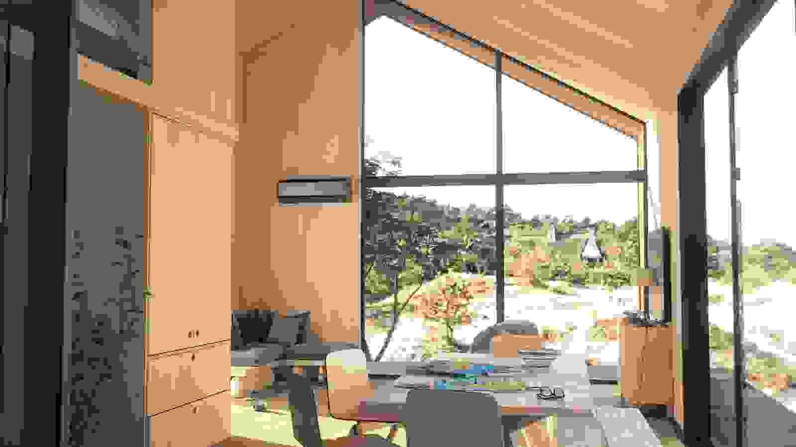 Bosch Climate luft/luftvärmepump installerad i ett modernt, ljust vardagsrum med stora fönster som vetter ut mot naturen